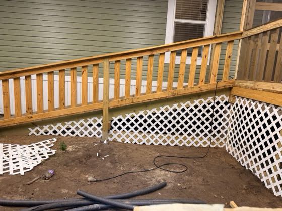 White lattice panels wrapping the corner of a raised deck.
